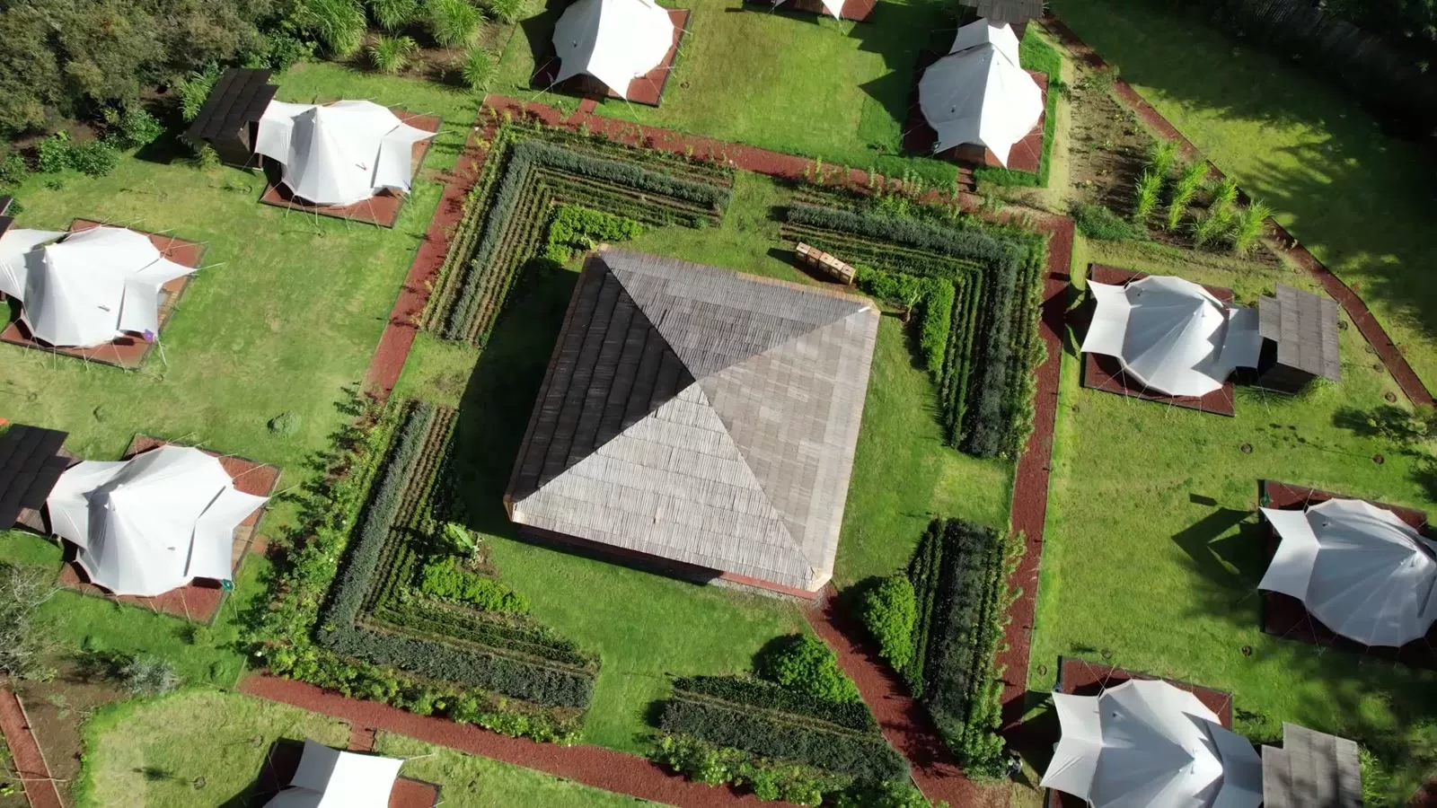 Aerial view of Attesi Lodge — glamping tents around a garden and central pavilion