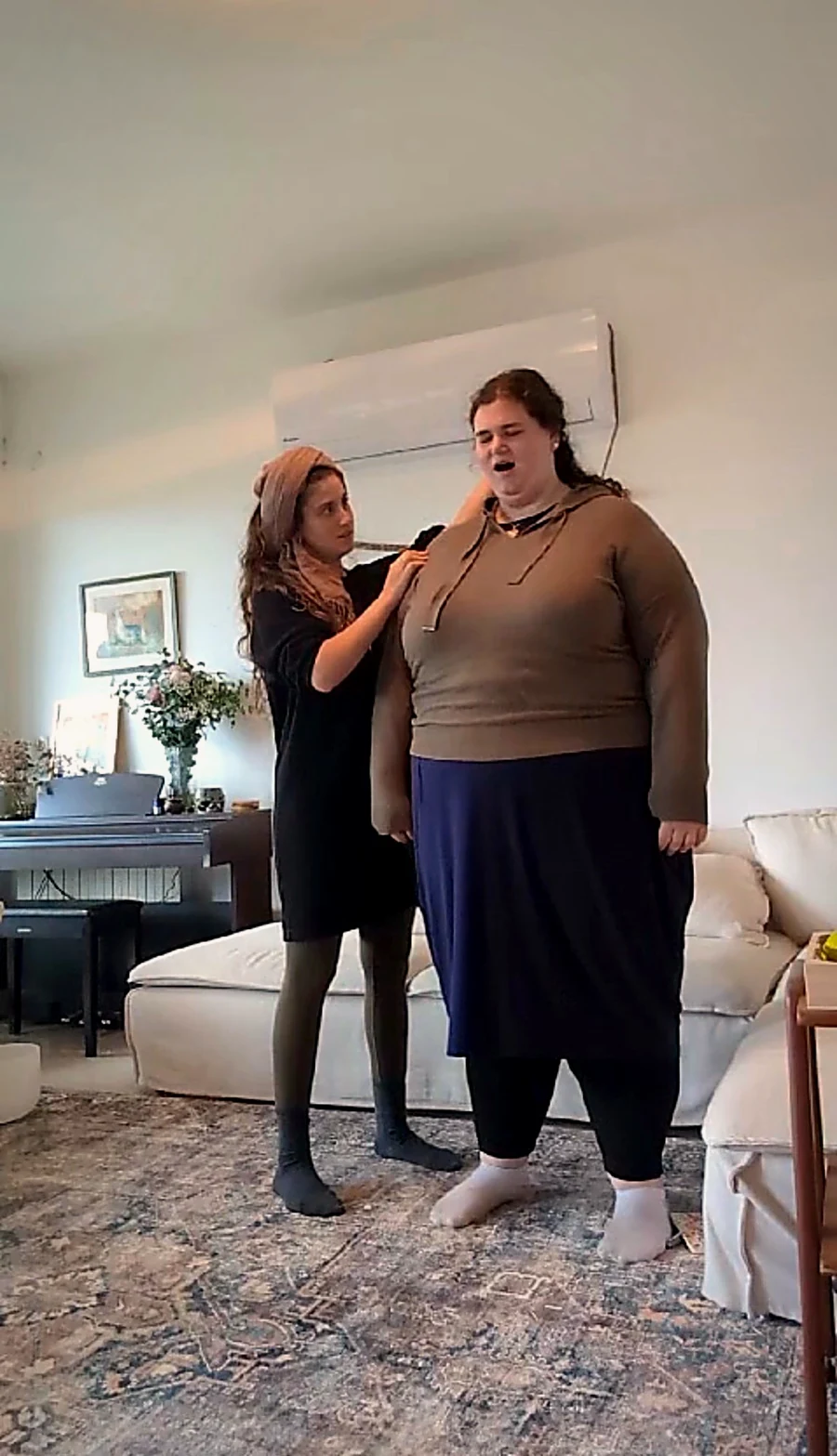 Tanya supporting a woman as she opens her voice