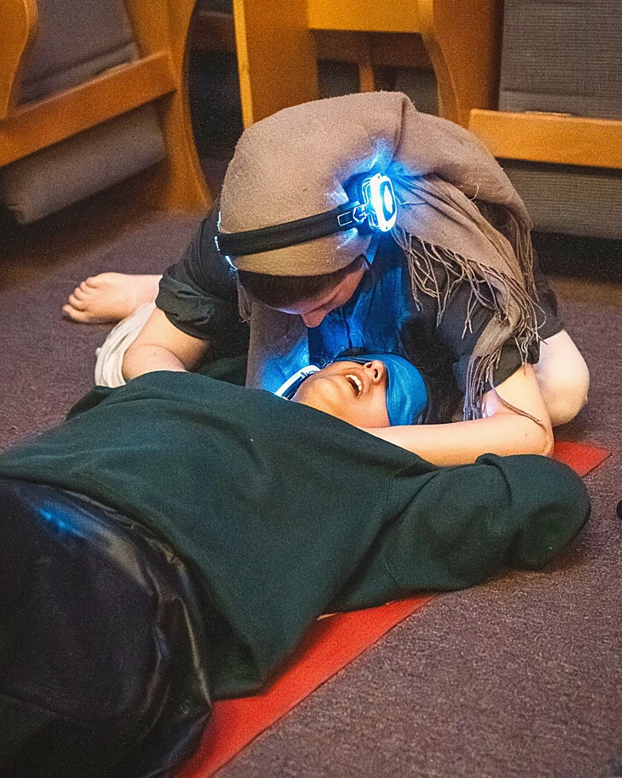 A woman held in a close, restorative breathwork moment